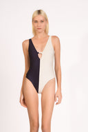 Model wearing the Bicolor Straps Swimsuit front color navy, made from 85% polyamide 15% elastane, styled for a beachwear look