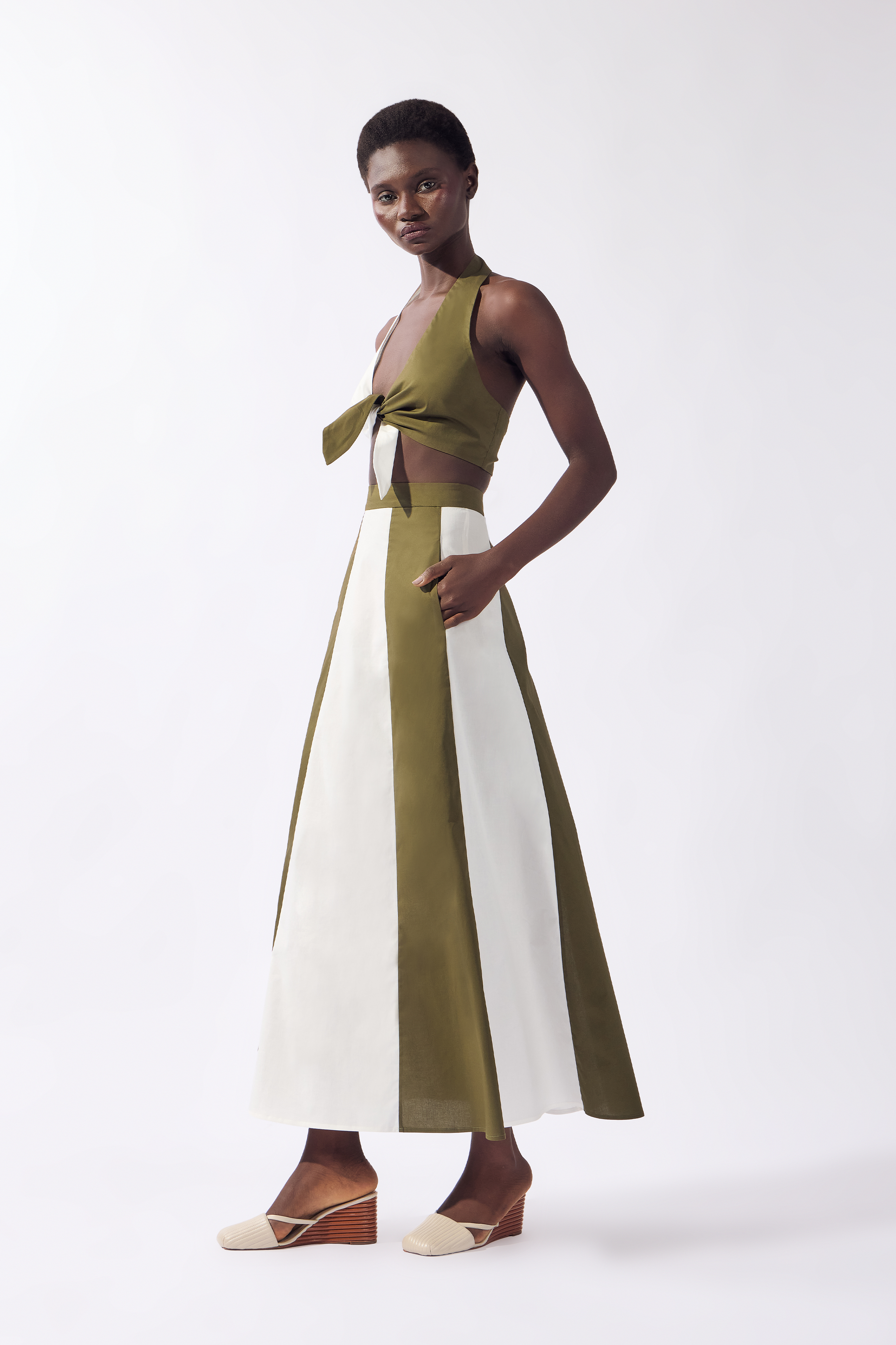 Model wearing the Bicolor Top & Skirt Set look, color off white and green, made from 98 cotton 2% elastane, styled for a resort look