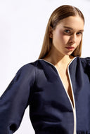 Model wearing the Bicolor V-Neck Romper detail color navy made with 56% viscose 44% Linen, styled for resortwear look