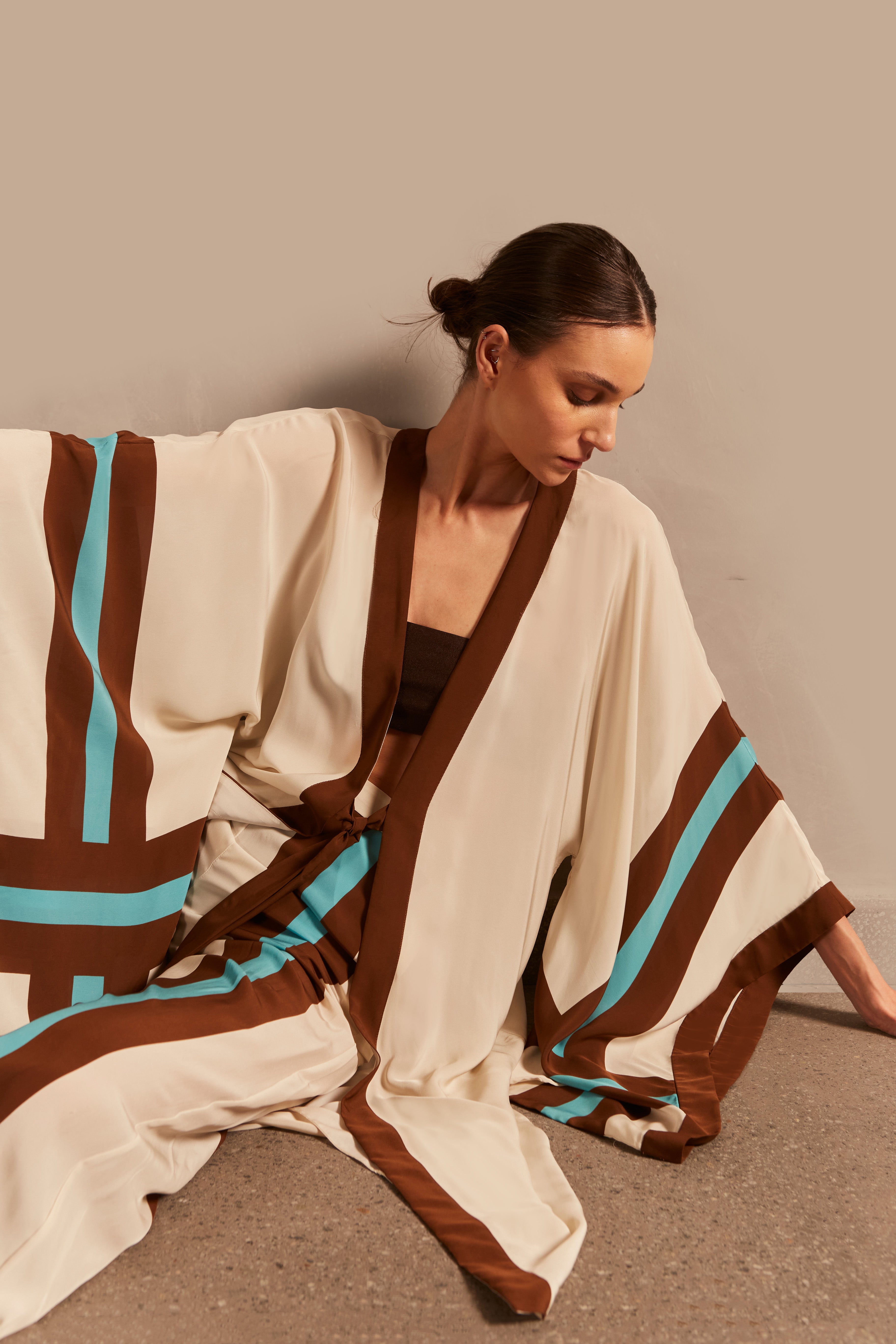 Model wearing the Bold Stripes Long Robe Front showcasing its Unique print on 100% Viscose fabric, styled for an afternoon look.