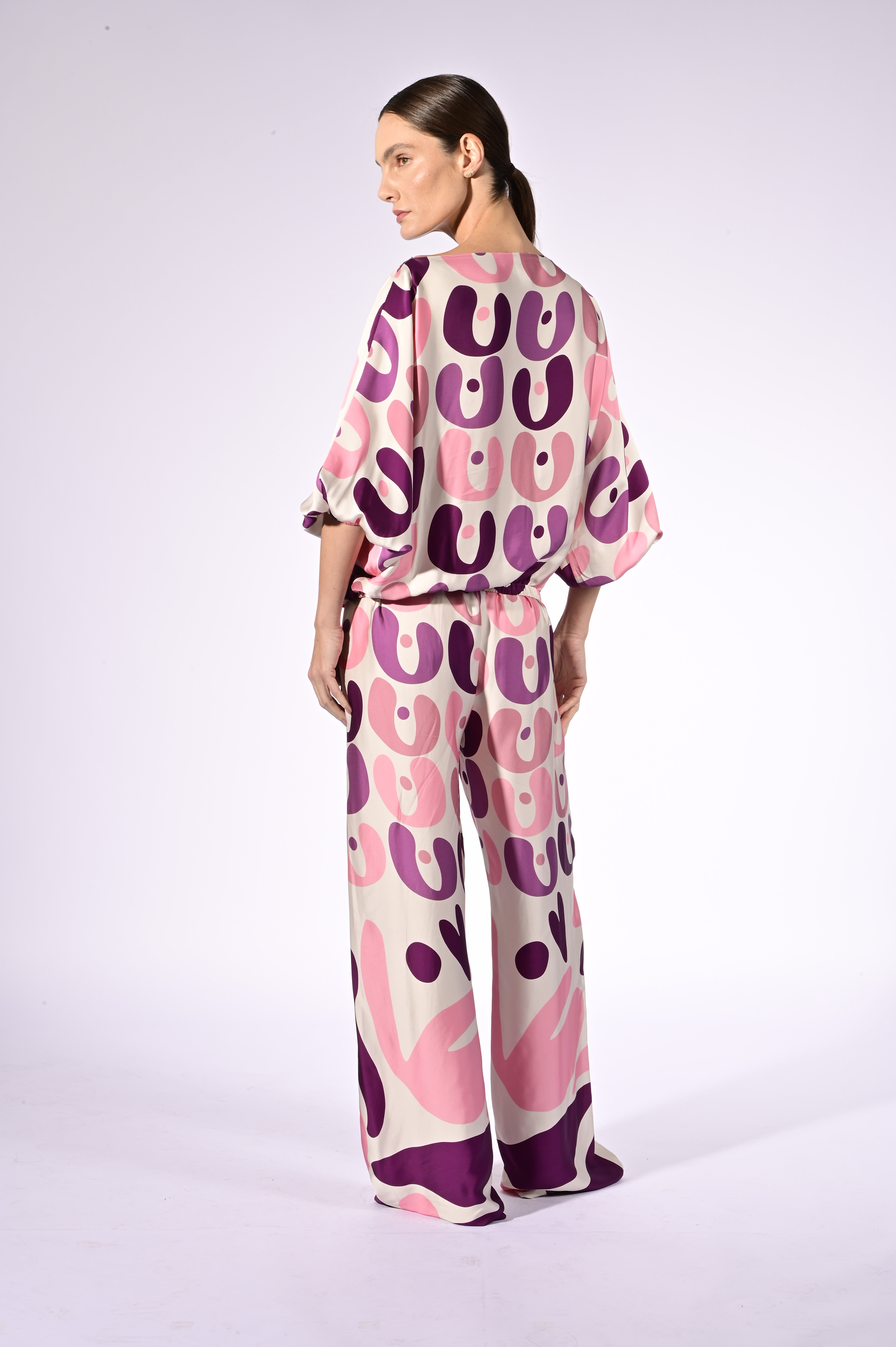 Model wearing the Bold Floral Boat Neck Blouse back color unique, made from 100% viscose, styled for a resort look