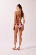 Model wearing the Bold Floral Classic Triangle Bikini back color unique, made from 85% polyamide 15% elastane, styled for a beachwear look