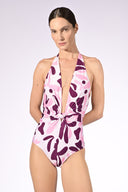 Model wearing the Bold Floral Halter Swimsuit detail color unique, made from 85% polyamide 15% elastane, styled for a beachwear look