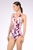 Model wearing the Bold Floral Halter Swimsuit side color unique, made from 85% polyamide 15% elastane, styled for a beachwear look