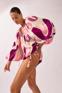 Model wearing the Bold Floral Puff Sleeve Mini Dress side color unique, made from 100% viscose, styled for a beachwear look