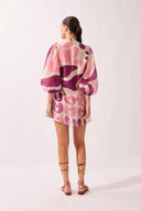 Model wearing the Bold Floral Shirt back color unique, made from 75% Lyocell 25% Polyester, styled for a beachwear look