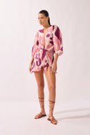 Model wearing the Bold Floral Shirt look color unique, made from 75% Lyocell 25% Polyester, styled for a beachwear look