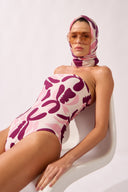 Model wearing the Bold Floral Strapless Swimsuit detail color unique, made from 85% polyamide 15% elastane, styled for a beachwear look