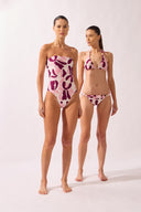 Model wearing the Bold Floral Strapless Swimsuit look color unique, made from 85% polyamide 15% elastane, styled for a beachwear look
