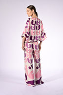 Model wearing the Bold Floral Wide-Leg Pants back color unique, made from 100% viscose, styled for a resort look