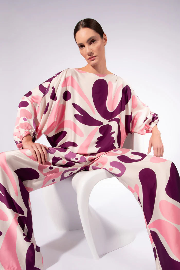 Model wearing the Bold Floral Wide-Leg Pants front color unique, made from 100% viscose, styled for a resort look