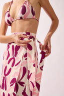 Model wearing the Bold Floral Wrap Pareo detail color unique, made from 100% viscose, styled for a beachwear look