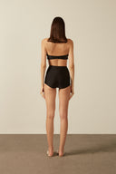 Model wearing the Solid High-Waisted Bikini Set back, made from 85% polyamide 15% elastane, styled for a beachwear look