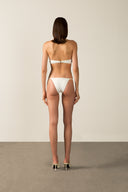Model wearing the  Coquille De Mer Halterneck Bikini off white back from the HS25 with 76.3% Polyamide 23.7% Elastane styled for a pool party look. 