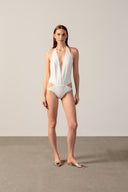 Model wearing the Coquille De Mer Plunge-Neck Swimsuit off white front from the HS25 with 76.3% Polyamide 23.7% Elastane styled for a pool party look.   