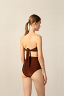 Model wearing the Corduroy High-Leg Strapless Bikini cacau color back from the HS25 with 85% Polyamide 15% Elastane styled for a beach look.   
