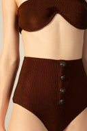 Model wearing the Corduroy High-Leg Strapless Bikini cacau color detail from the HS25 with 85% Polyamide 15% Elastane styled for a beach look.   