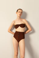 Model wearing the Corduroy High-Leg Strapless Bikini cacau color pose from the HS25 with 85% Polyamide 15% Elastane styled for a beach look.   