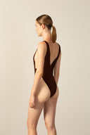 Model wearing the Corduroy High-Leg Swimsuit cacau color back from the HS25 with 85% Polyamide 15% Elastane styled for a beach look.   