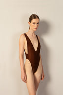 Model wearing the Corduroy High-Leg Swimsuit cacau color front from the HS25 with 85% Polyamide 15% Elastane styled for a beach look.   