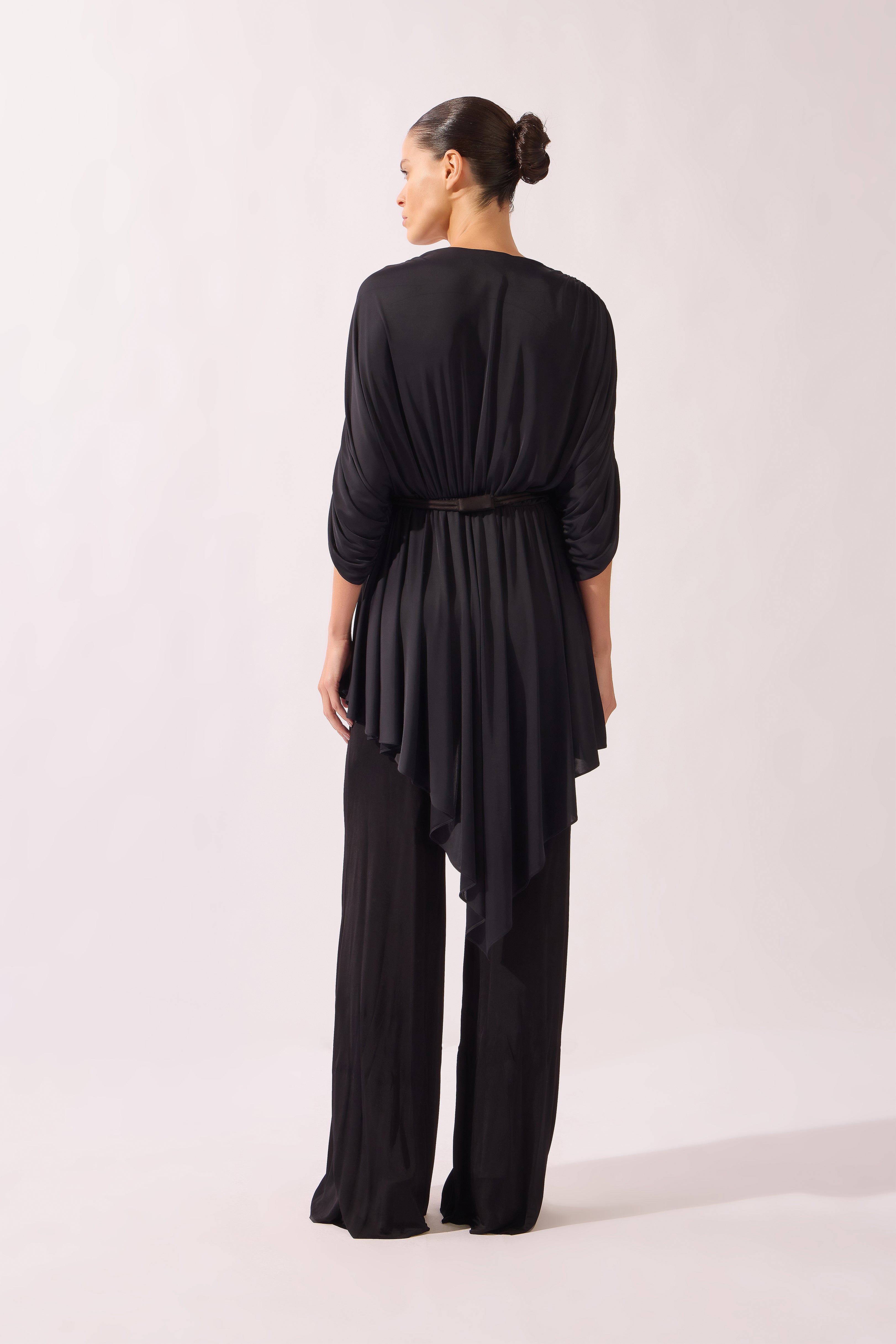 Model wearing the Dolman Jersey Blouse back color black, made from 100% polyamide, styled for a resort look