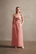 Model wearing the  Exotic Coral Solid Cut-Out Long Dress Front showcasing its Pink print on 98% Polyester 2% Elastane fabric, styled for an evening look. 