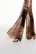Model wearing the Flared Silk Pants detail from the Adriana Degreas and Sabine Getty collab with 100% Silk styled for a casual look.
