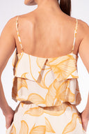 Model wearing the Foliage Crop Top detail color cashew yellow, made from 10% viscose, styled for a resort look
