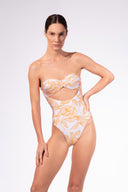 Model wearing the Foliage Cut-Out Swimsuit front color cashew yellow, made from 85% polyamide 15% elastane, styled for a resort look