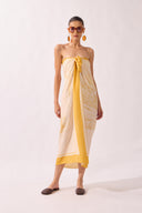 Model holding the Foliage Panneau, showcasing its yellow print on 100% viscose fabric.