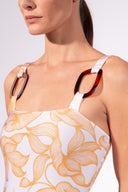 Model wearing the Foliage Straps Swimsuit detail color cashew yellow, made from 85% polyamide 15% elastane, styled for a beachwear look