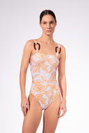 Model wearing the Foliage Straps Swimsuit front color cashew yellow, made from 85% polyamide 15% elastane, styled for a beachwear look