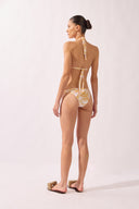 Model wearing the Foliage Triangle Bikini back color cashew yellow, made from 85% polyamide 15% elastane, styled for a beachwear look