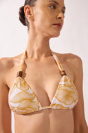 Model wearing the Foliage Triangle Bikini detail top color cashew yellow, made from 85% polyamide 15% elastane, styled for a beachwear look