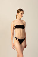 Model wearing the Geometric Bandeau Bikini black pose from the HS25 with 85% Polyamide 15% Elastane styled for a beach look.   