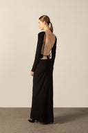 Model wearing the Geometric Long-Sleeved Bare-Back Long Dress black detail from the HS25 with 92% Polyester 8% Polyamide styled for a date look.   