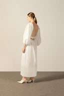 Model wearing the Geometric Puff-Sleeved Long Dress back color off white with 98% cotton and 2% elastane fabric styled for a resort look