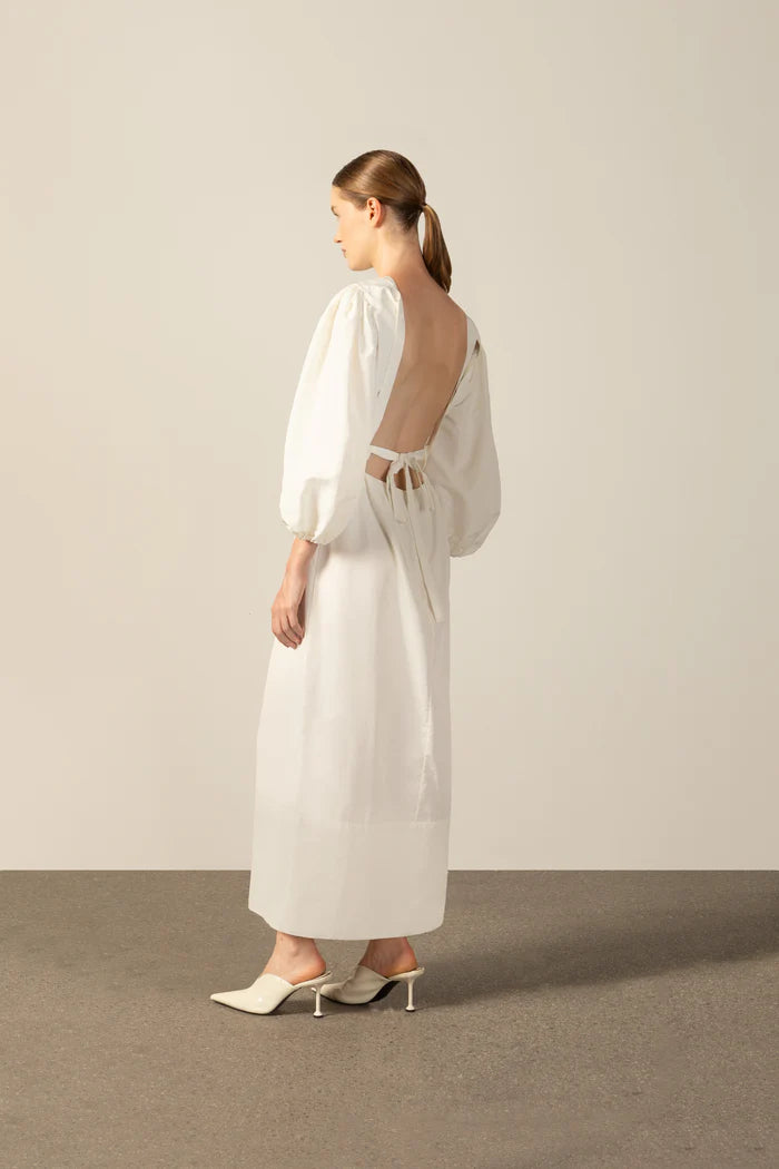 Model wearing the Geometric Puff-Sleeved Long Dress back color off white with 98% cotton and 2% elastane fabric styled for a resort look
