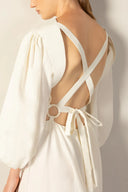 Model wearing the Geometric Puff-Sleeved Long Dress detail color off white with 98% cotton and 2% elastane fabric styled for a resort look