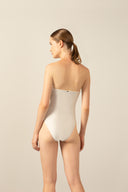 Model wearing the  Geometric Strapless Swimsuit off white back from the HS25 with 85% Polyamide 15% Elastane styled for a beach look. 