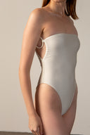 Model wearing the  Geometric Strapless Swimsuit off white detail from the HS25 with 85% Polyamide 15% Elastane styled for a beach look. 