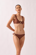 Model wearing the Geometric Straps Bikini cappuccino front from the HS25 with 85% Polyamide 15% Elastane styled for a beach look.  