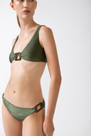 Model wearing the Geometric Straps Bikini croco green detail from the HS25 with 85% Polyamide 15% Elastane styled for a beach look.  