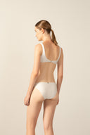 Model wearing the Geometric Straps Bikini off white back from the HS25 with 85% Polyamide 15% Elastane styled for a beach look.  