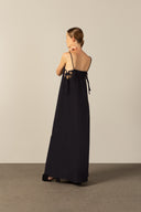 Model wearing the Geometric Straps Long Dress navy back from the HS25 with 100% polyester styled for a beach look.   