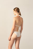 Model wearing the Geometric Triangle Bikini off white back from the HS25 with 85% Polyamide 15% Elastane styled for a beach look.  
