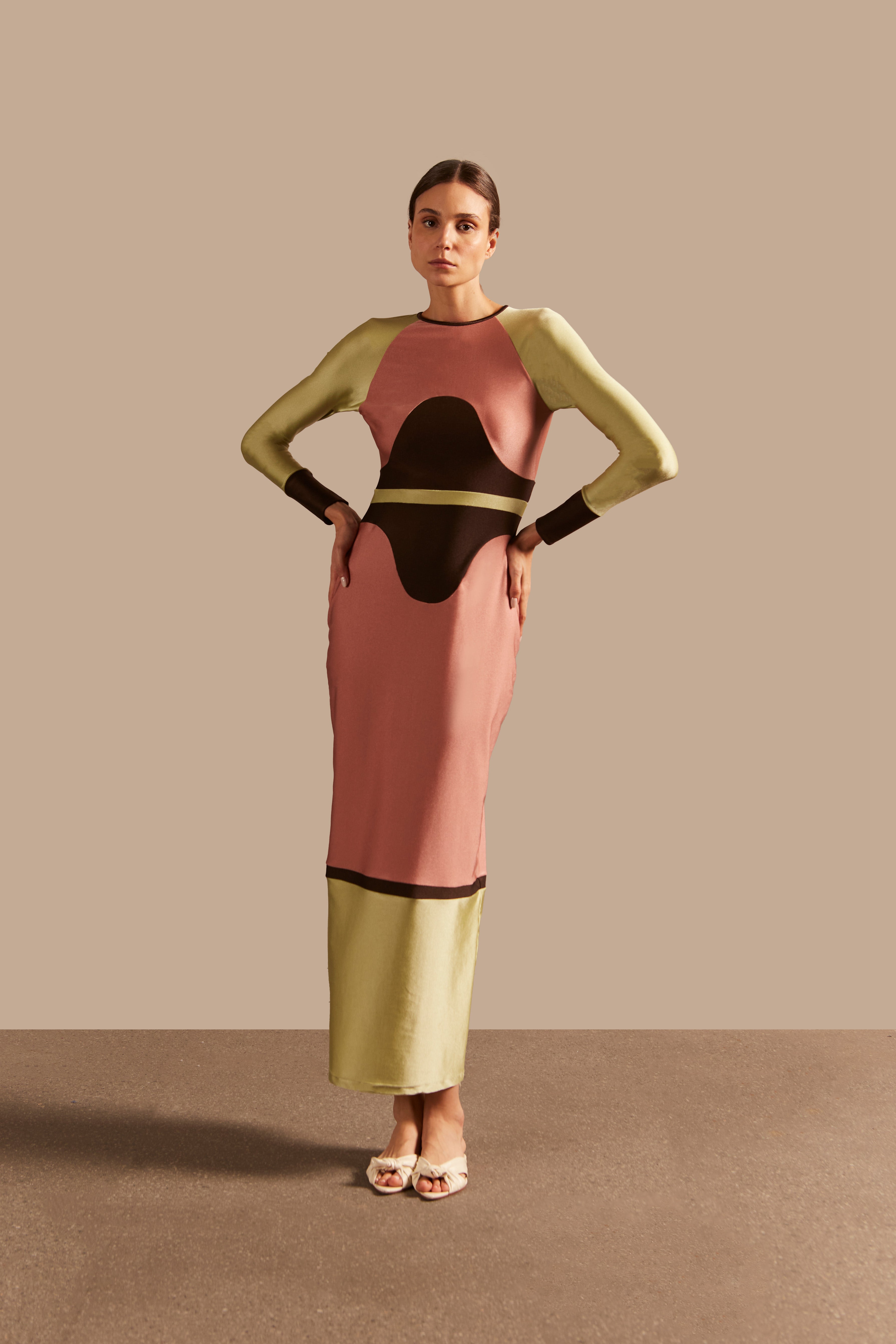 Model wearing the Giardino Long Dress Concept showcasing its Pink/Coffee/Green Olive color on 85% Polyamide 15% Elastane fabric, styled for an afternoon look.  
