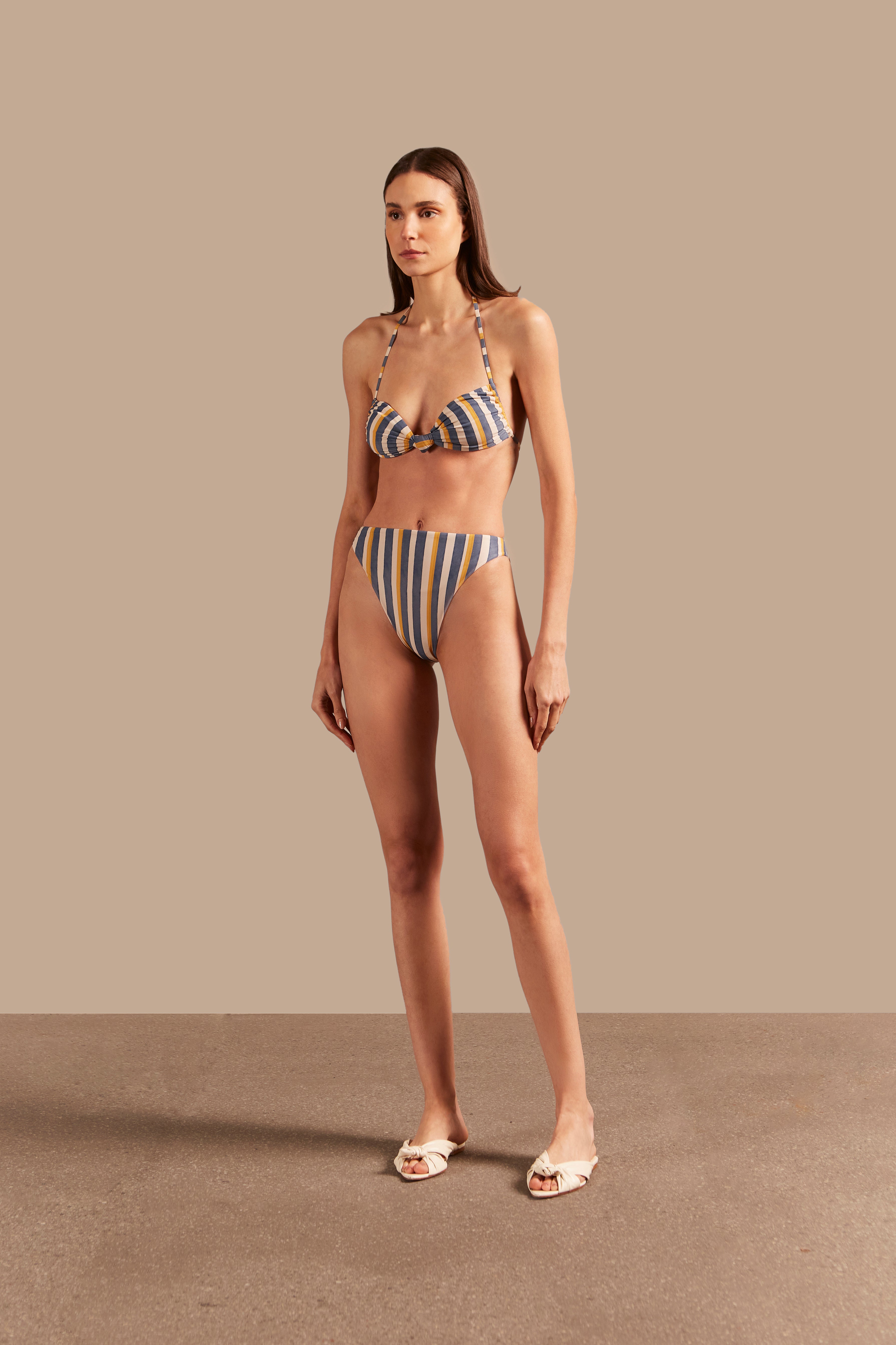 Full front view of the Golden Age High-Leg Bikini featuring a striped design in blue, off-white, and yellow with a halterneck top and high-leg bottom.