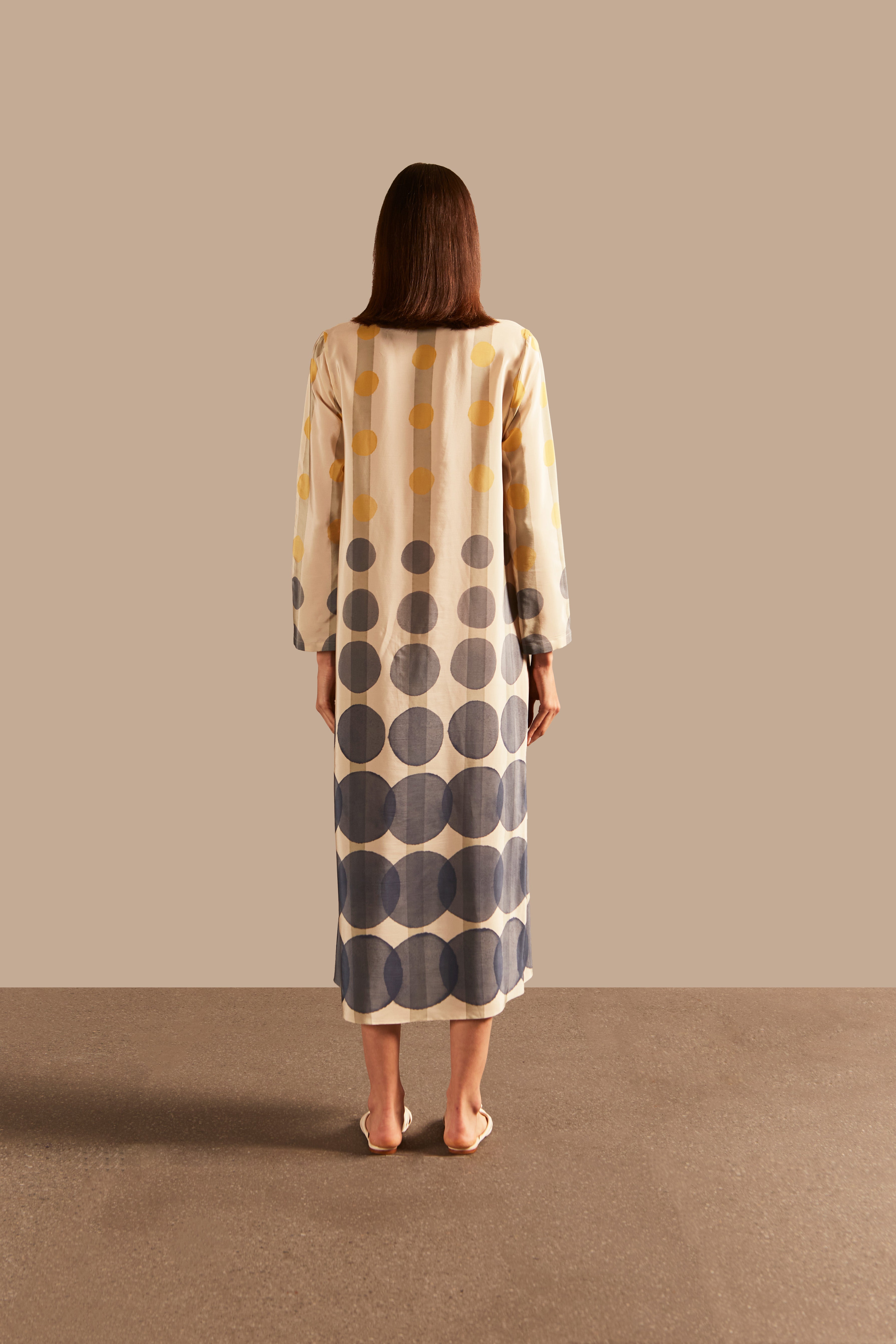 Back view of the Golden Age Long Dress showcasing its flowing silhouette and vintage-inspired print in off-white, blue, and yellow.