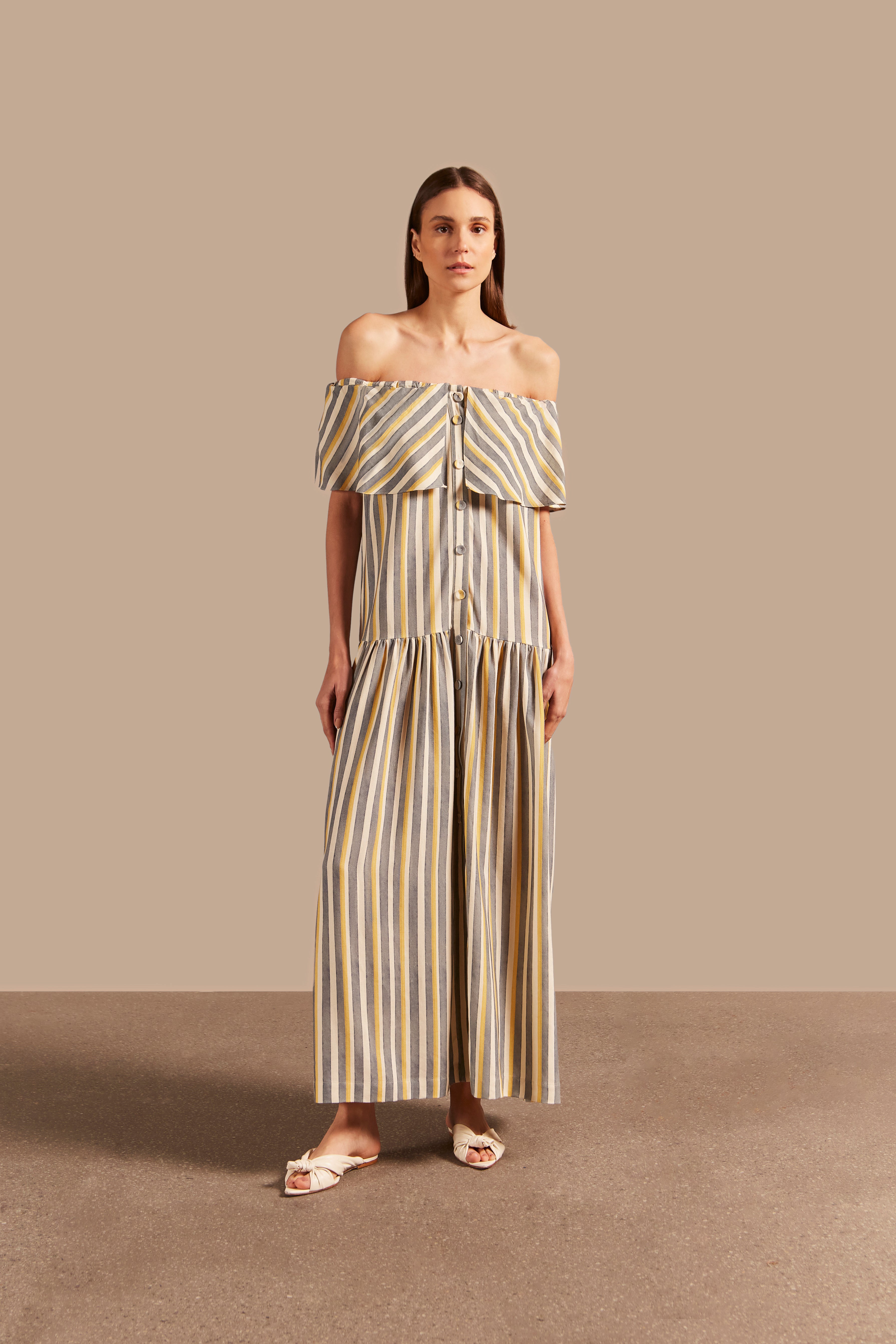 Full front view of the Golden Age Off-The-Shoulder Long Dress featuring a striped design in grey, off-white, and yellow with fluid modeling.